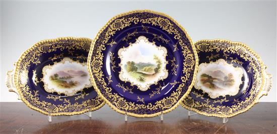 A Coalport named view plate and a pair of matching dessert dishes, c.1900, 26.5cm and 28cm